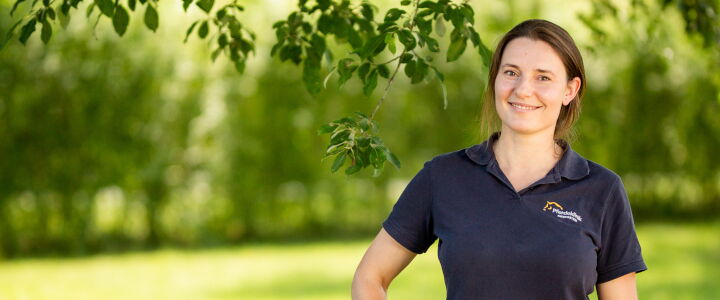Jenny Lenz unter einem Baum in einem grünem Garten
